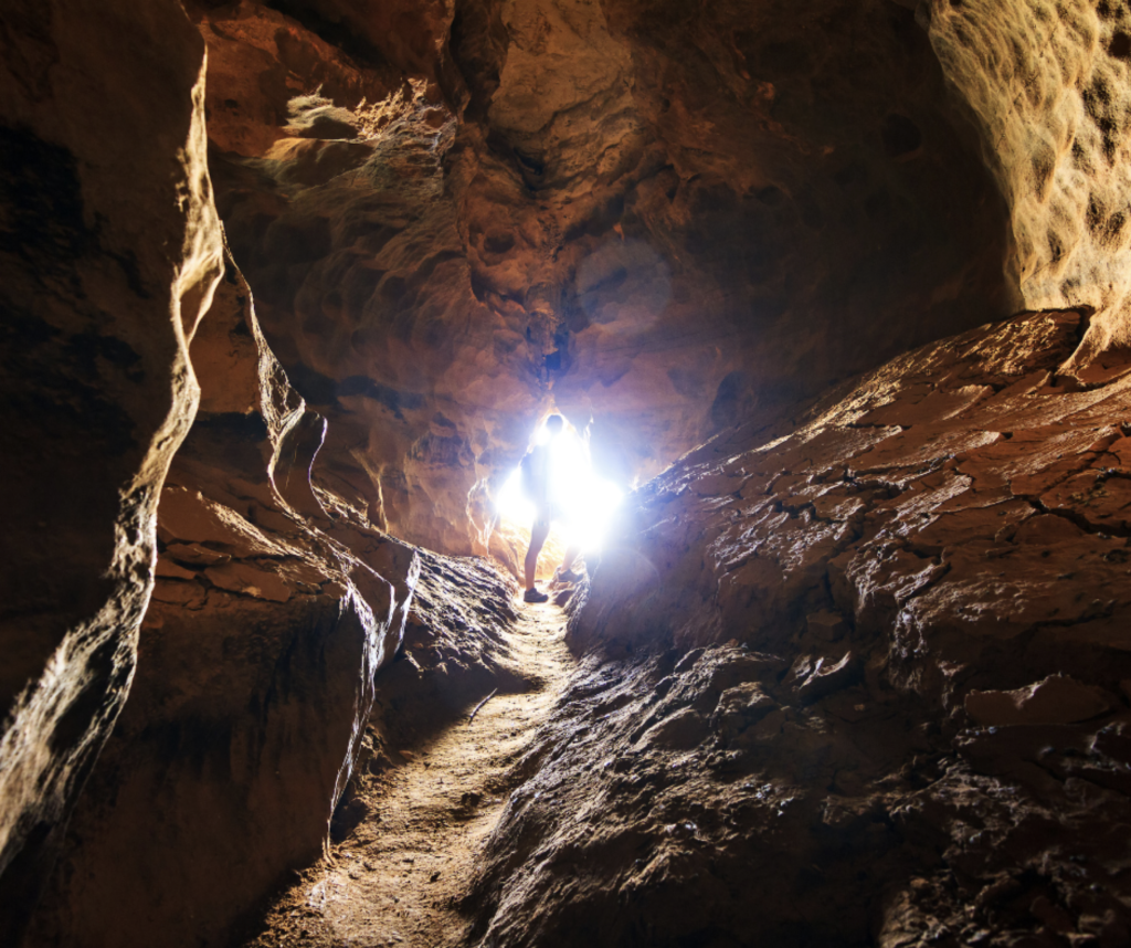 A man standing in a cave with bright light pouring in from beyond him. Rabeinu Baḥya ben Asher ben Ḥlava—13th c. kabbalistic commentator—teaches that just like our eyes can get overwhelmed by light, our souls can get overpowered by the light of God.