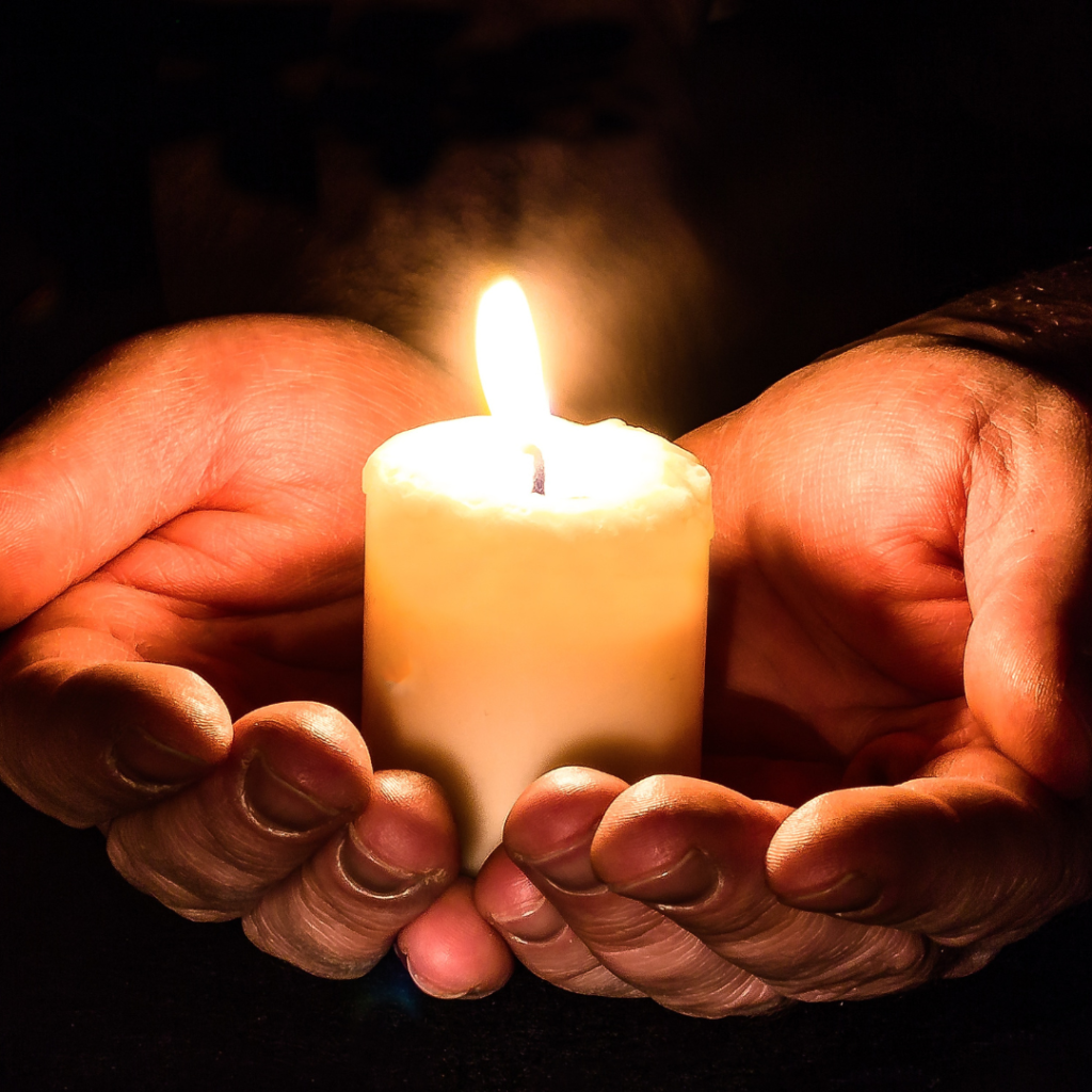 Hands holding a candle in welcome. Universal.